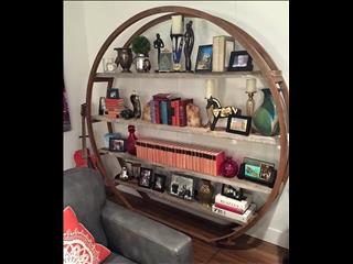 Shelving unit made from an industrial wire s spool. 