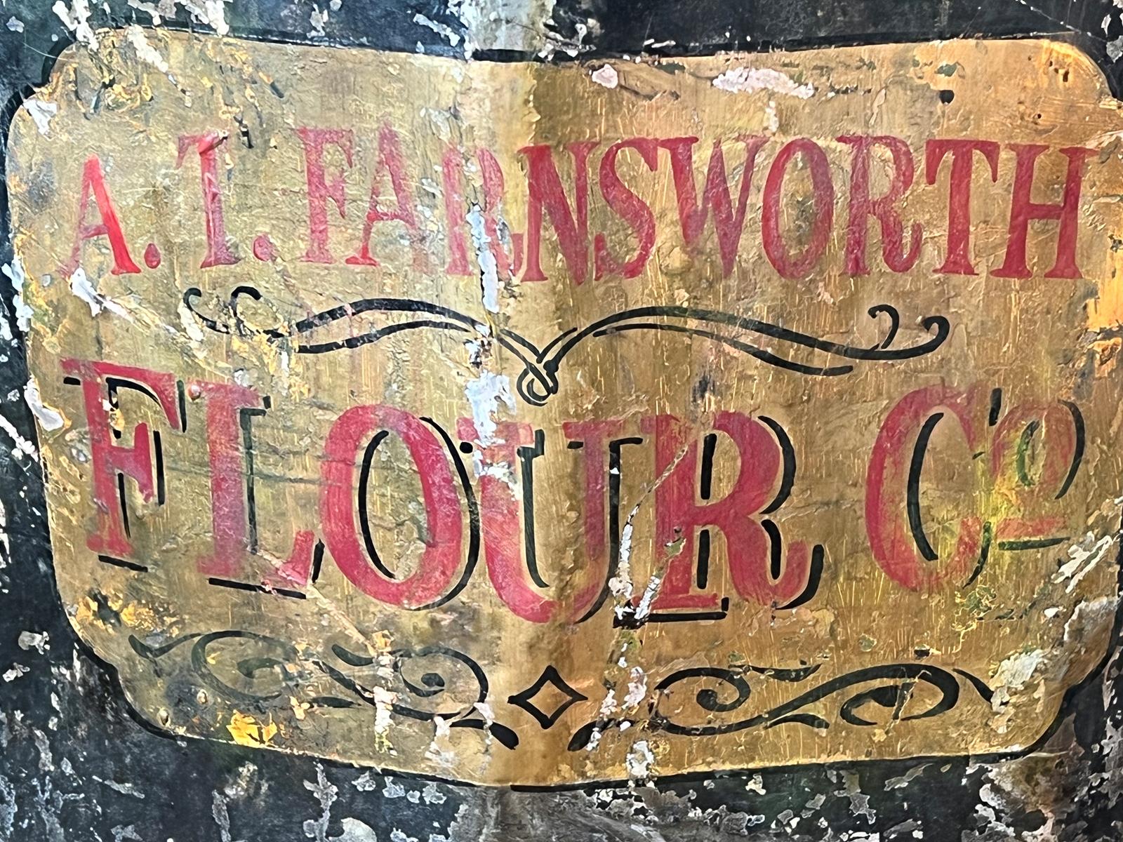 A close-up of the label and tagging on an old flour bin